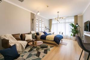 een woonkamer met een bed en een bank bij Wuhan Wuchang·Star City· Locals Apartment 00121940 in Wuhan