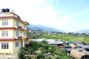 a yellow building with a view of a field at Green Eco Resort in Kirtipur
