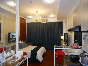 a hotel room with a bed and a chandelier at Trillium Residences Ayala Cebu in Cebu City