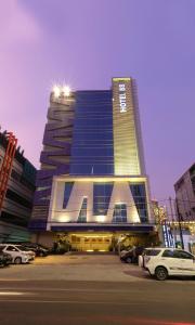 a tall building with cars parked in front of it at Hotel 88 Mangga Besar 62 - Best Breakfast - Near By Ancol And Government Center in Jakarta