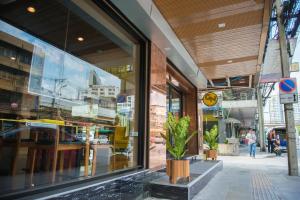 a store front with a large glass window of a building at GN Luxury Hostel in Bangkok