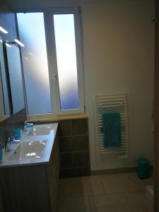 a bathroom with a sink and a window at beau T2 lumineux 1er etage in Rochefort