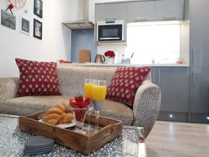 a living room with a couch and a tray with a glass of orange juice at Prosecco Palace in York