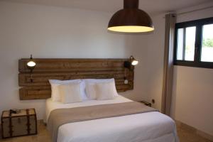 a bedroom with a large bed with a wooden headboard at Villa Madra in Bonifacio