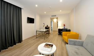 a living room with a couch and a table at Hotel Salobreña Suites in Salobreña