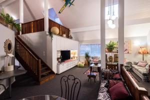 a living room with a couch and a tv at Land Of Lost Treasure in Maleny