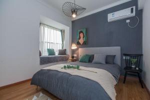 a bedroom with a bed with a fan on the wall at Wuhan Jiangan·Aeon Commercial City· Locals Apartment 00152860 in Wuhan