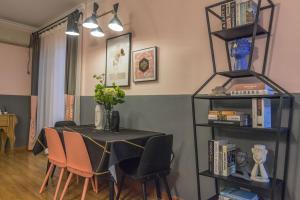 a dining room with a table and chairs and a book shelf at Wuhan Jiangan·Aeon Commercial City· Locals Apartment 00152860 in Wuhan