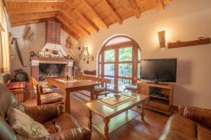 a living room with leather furniture and a tv at Villa Lucija in Gruda