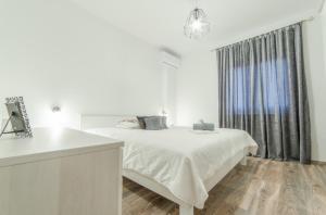 a white bedroom with a bed and a window at Villa Lucija in Gruda +38 photos