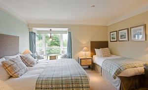 a hotel room with a bed and a desk at Anglesey Arms Hotel in Menai Bridge