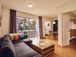 a living room with a couch and a table at Route Active Hotel in Los Realejos