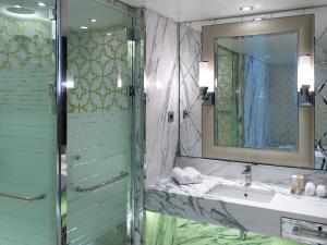 
a bathroom with a shower, sink, and mirror at Sunborn Gibraltar in Gibraltar
