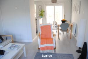 a living room with a couch and a table at Ash House in Uppingham