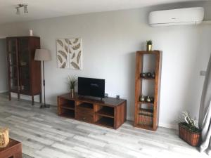 a living room with a flat screen tv sitting on a table at Campello Mistral in El Campello