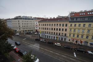 ウィーンにあるMCA Apartmentsの車や建物が停まる街道