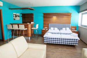 a bedroom with a bed and a blue wall at Restaurant & Design Hotel Noem Arch in Brno