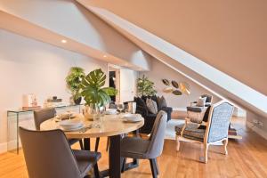 a dining room and living room with a table and chairs at Lisbon Finestay Mastro Apartments in Lisbon