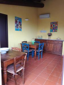 uma sala de jantar com mesas de madeira e cadeiras azuis em Agriturismo Il Colle em Bagno a Ripoli