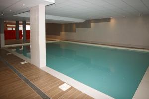 a large swimming pool in a building at Time to Ski - Porthos in Sainte-Foy-Tarentaise
