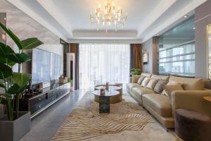 a living room with a large couch and a television at Wuhan Jianghan·Zhongshan Park· Locals Apartment 00157640 in Wuhan