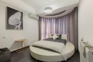 a bedroom with a bed with a round ottoman at Wuhan Jianghan·Zhongshan Park· Locals Apartment 00157640 in Wuhan