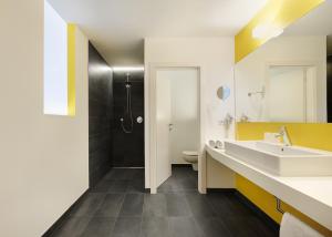 a bathroom with a sink and a shower at Hotel Tirolerhof in Rodengo