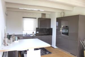 a kitchen with gray cabinets and a white counter top at Colle Divino in Würzburg