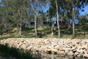 a rock retaining wall next to a body of water at Levi Adelaide Holiday Park in Adelaide