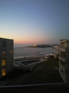 a view of the sunset from the balcony of a building at A310 Lagoon Beach Apartment & Spa in Cape Town