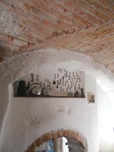 a shelf with pots and pans on a wall at B&B Renzano bedrooms in Salò