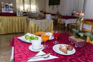 a table with plates of food and glasses of wine at Hotel Trianon in Bellaria-Igea Marina