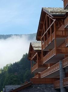 a building with a view of a foggy mountain at Time to Ski - La Niche in Sainte-Foy-Tarentaise