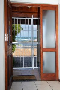 an open door with a view of the beach at Melkboom in Franskraal
