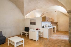 a kitchen with a counter and a table with a desk at Honorê - Suite Romain Rolland in Lyon