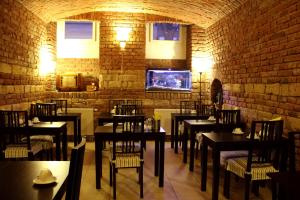 a restaurant with tables and chairs and a brick wall at Hotel Trevi in Prague