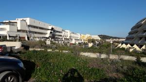 a car parked in front of a row of buildings at Naturist Paradise in « Swinging Cap » in Cap d'Agde