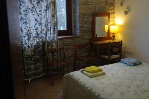 a bedroom with a bed and a table and a mirror at Fattoria La Guedrara in Sestola