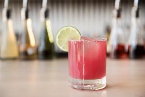 a drink with a slice of lime in a glass at Boro Hotel in Queens