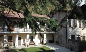 a large house with a porch and a yard at Corte del Cedro in Provaglio d'Iseo