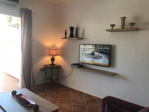 a living room with a flat screen tv on a wall at Mirador Golf in Cabo Negro