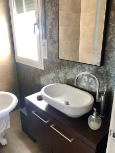 a bathroom with a white sink and a mirror at Chalet en Espinosa Monteros in Espinosa de los Monteros