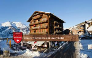 a sign that says you are welcome to our luxury hotel at Hotel Walliserhof - The Dom Collection in Grächen