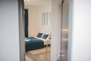 A bed or beds in a room at Rába Apartman House