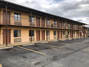 a building with balconies on the side of a parking lot at Motor Inns Of America in Madisonville