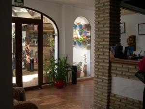 an entrance to a store with a plant in a room at Hotel Cortijo Los Gallos in Chiclana de la Frontera