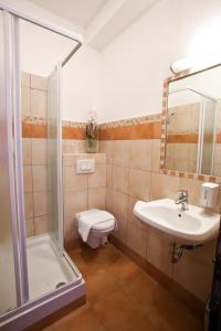 a bathroom with a toilet and a sink and a shower at Guesthouse KUBUS in Ljubljana