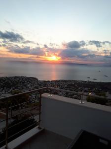 a view of the sunset from the balcony of a house at Viva B&B in Anavissos