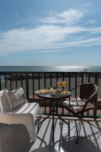 a table and chairs on a balcony with the ocean at Dulce Mare in Salerno