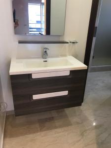 a bathroom with a sink and a mirror at Le nid du centre ville in Rabat